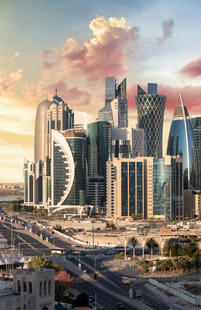the city center of doha, qatar, at sunset with clouds